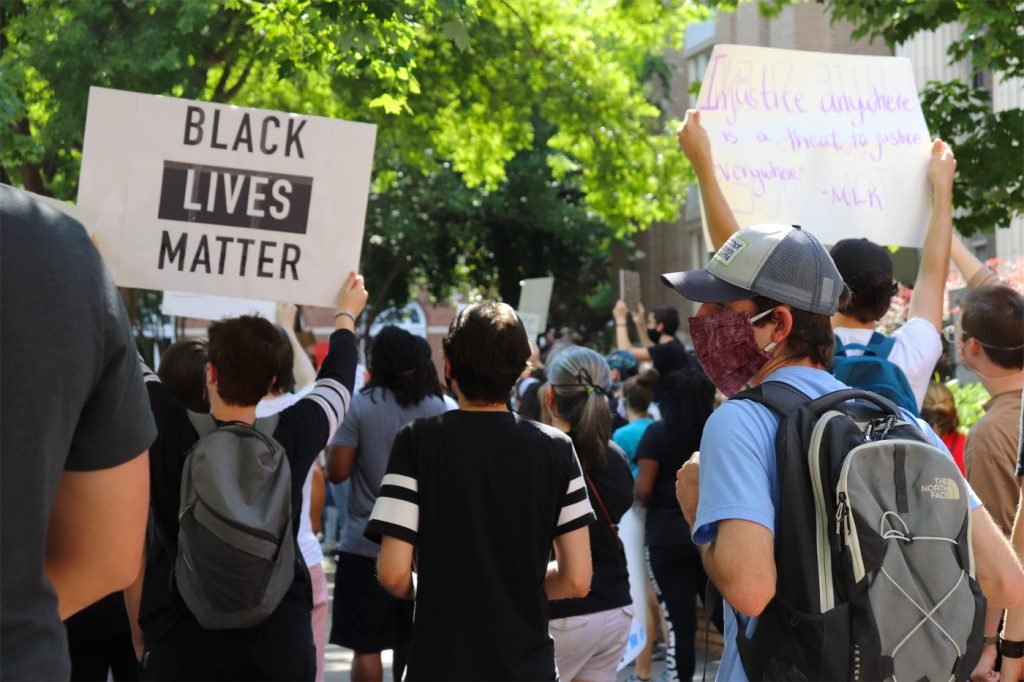 Protesters holding signs