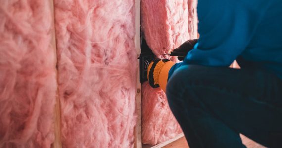 A man installing insulation