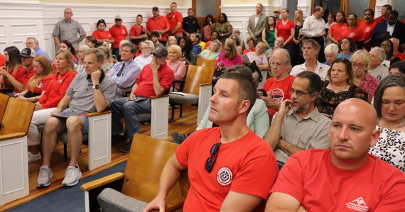 Firefighters pack city hall