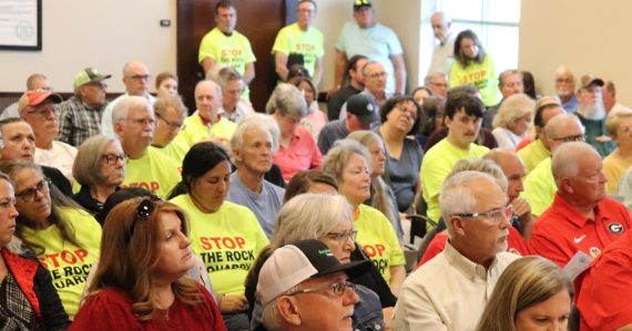 A group of people, some wearing "Stop the Rock Quarry" t-shirts.