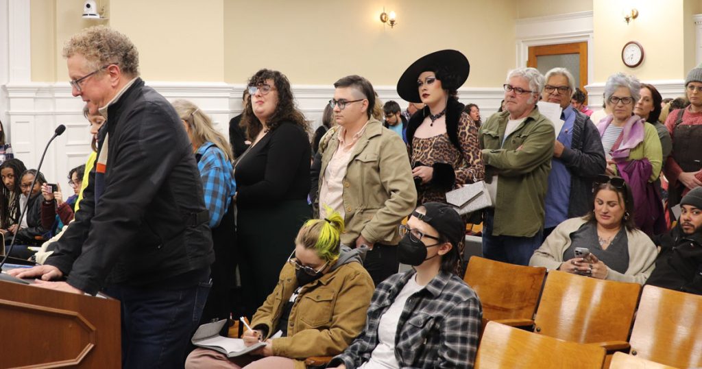 A line of speakers at the podium at city hall in Athens, GA