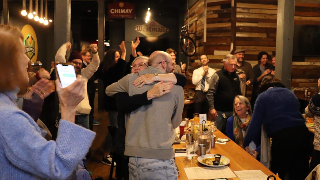 People cheering and hugging