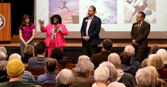 A panel of speakers addressing the audience