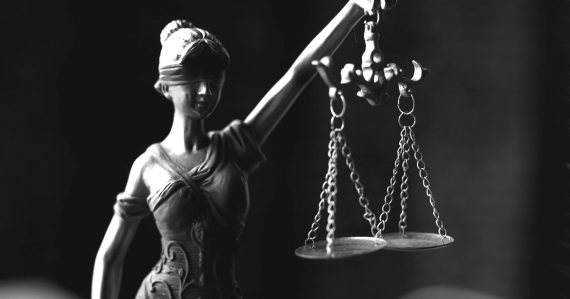 statue of blind justice with a set of scales